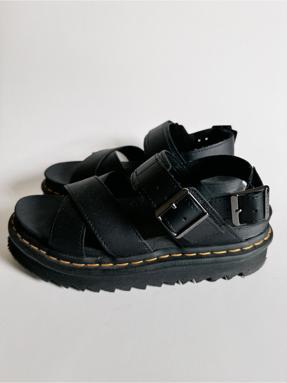 Dr. Martens Black Leather Lug-Sole Sandals with Yellow Stitching